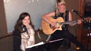 Rachel (R) plays the guitar, and Jori (L) plays the piano. They entertain with a variety of songs from as early as the 1960s through the present.