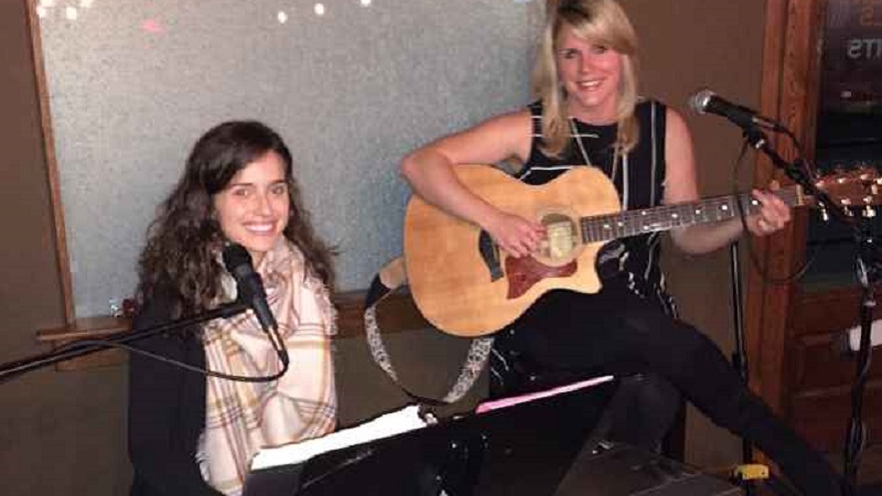 Rachel (R) plays the guitar, and Jori (L) plays the piano. They entertain with a variety of songs from as early as the 1960s through the present.